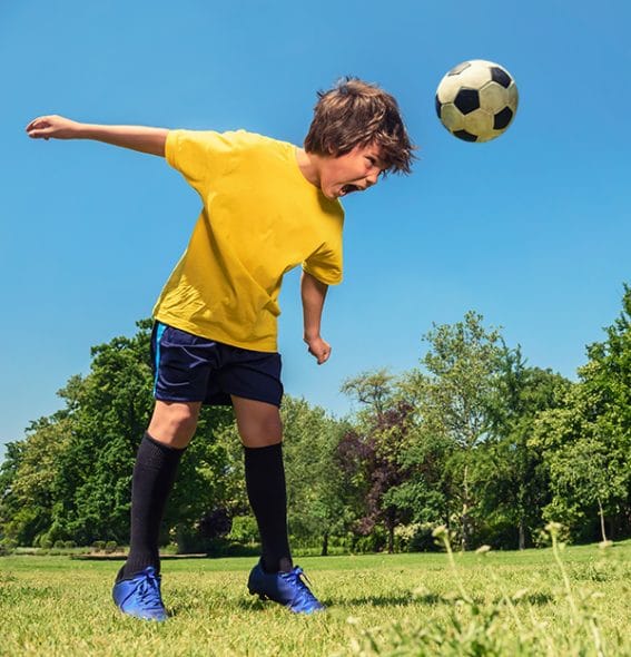 A boy heading a ball